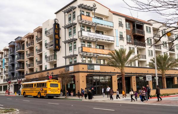 A 5-over-1 residential building with ground-floor commercial space. 