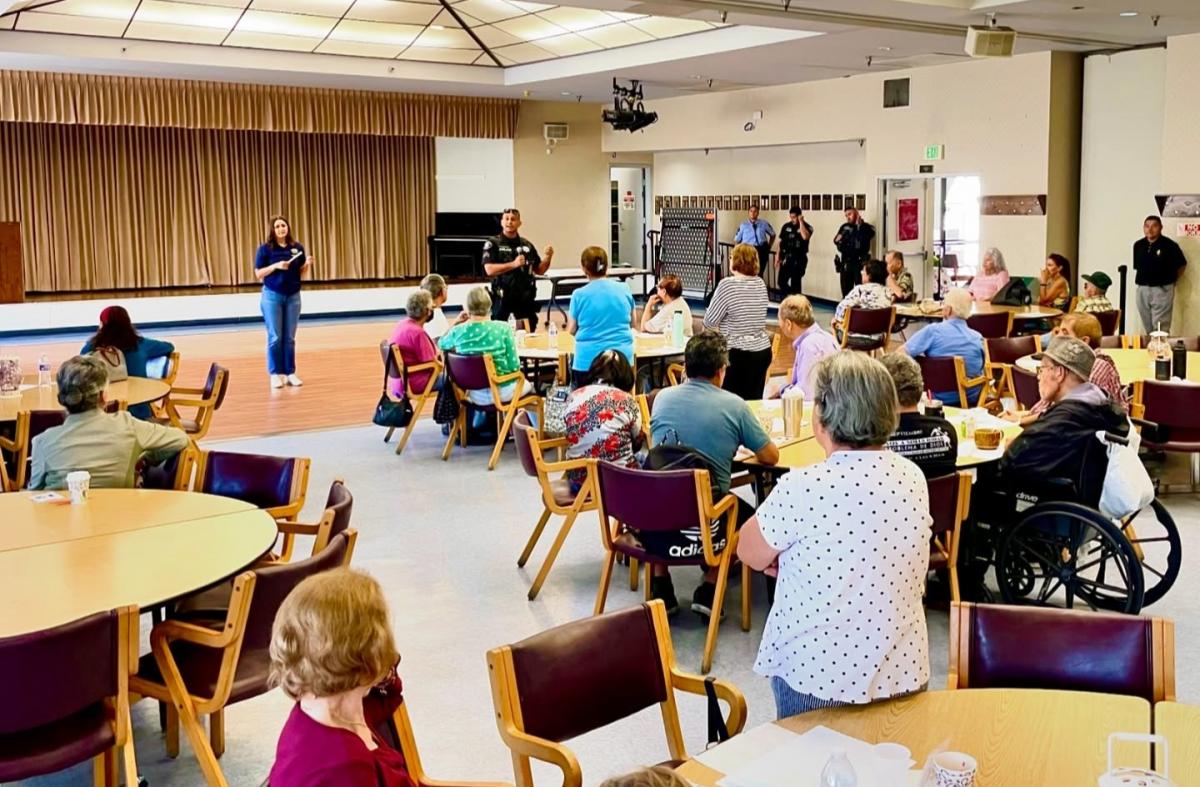 Police officers speaking at a local senior center