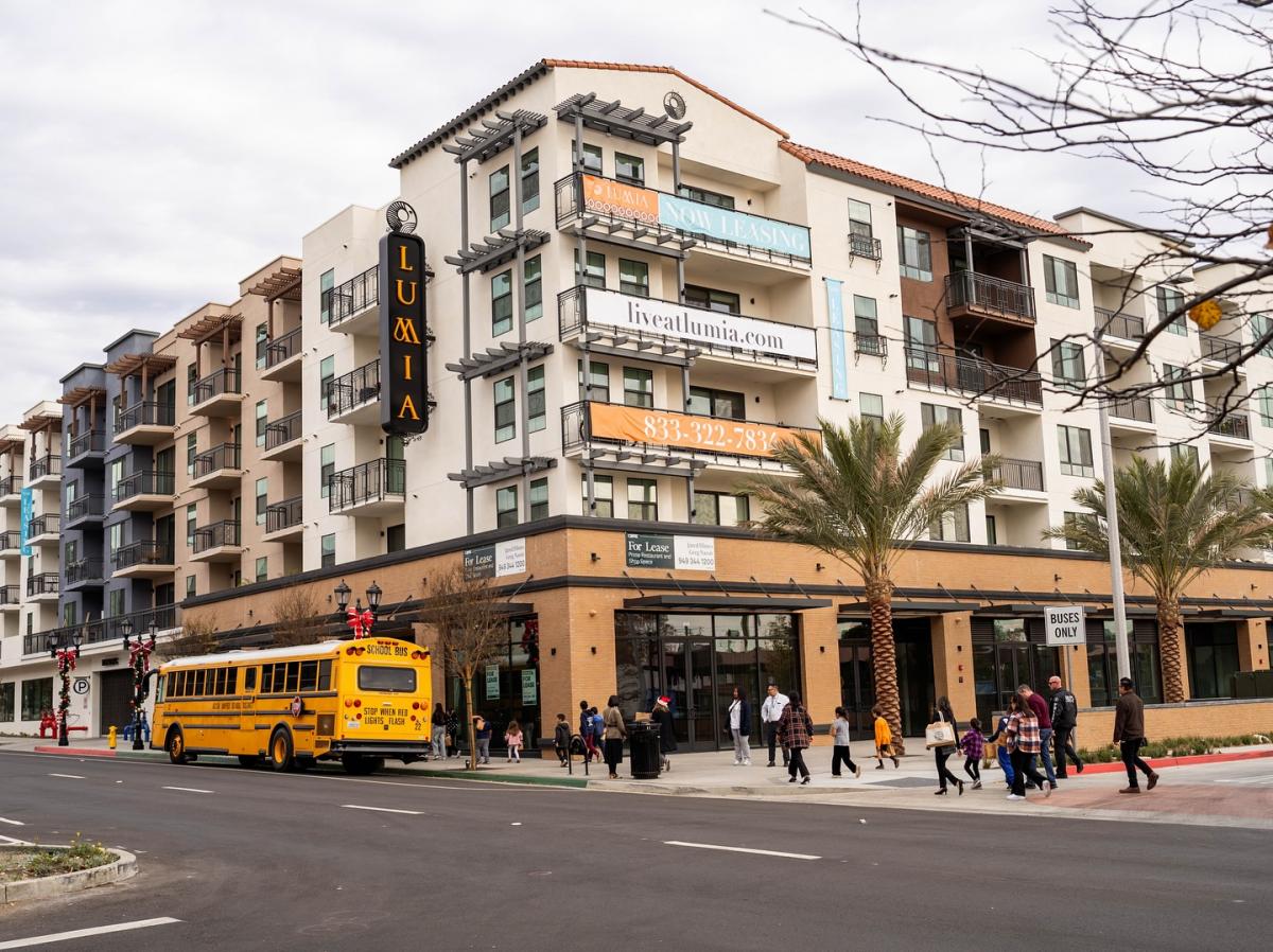 A 5-over-1 residential building with ground-floor commercial space. 