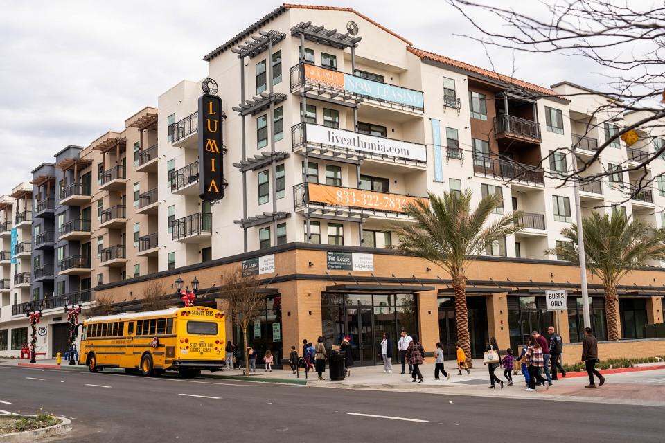 A 5-over-1 residential building with ground-floor commercial space. 